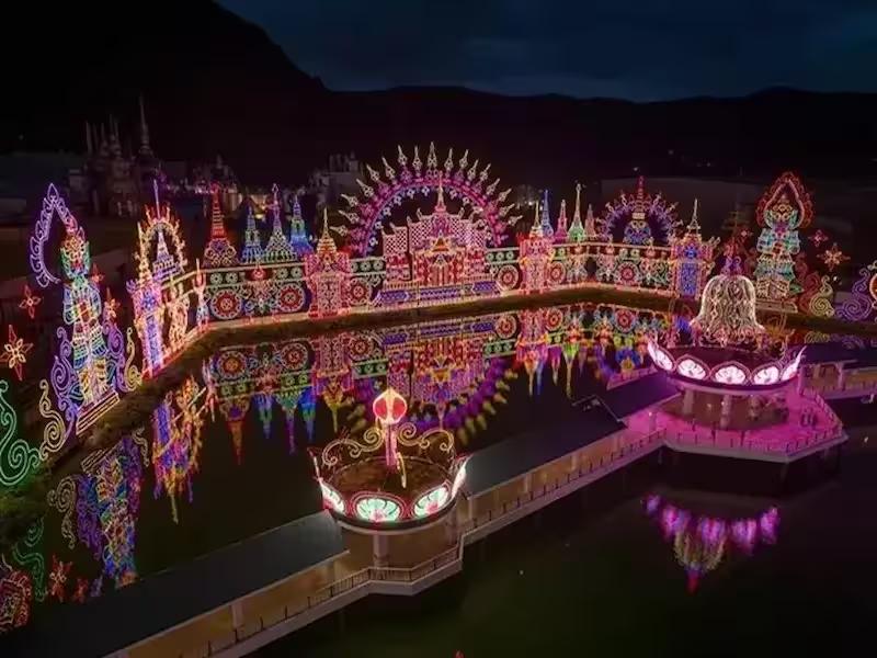 The vibrant and colorful main entrance of Carnival Magic Phuket theme park at night
