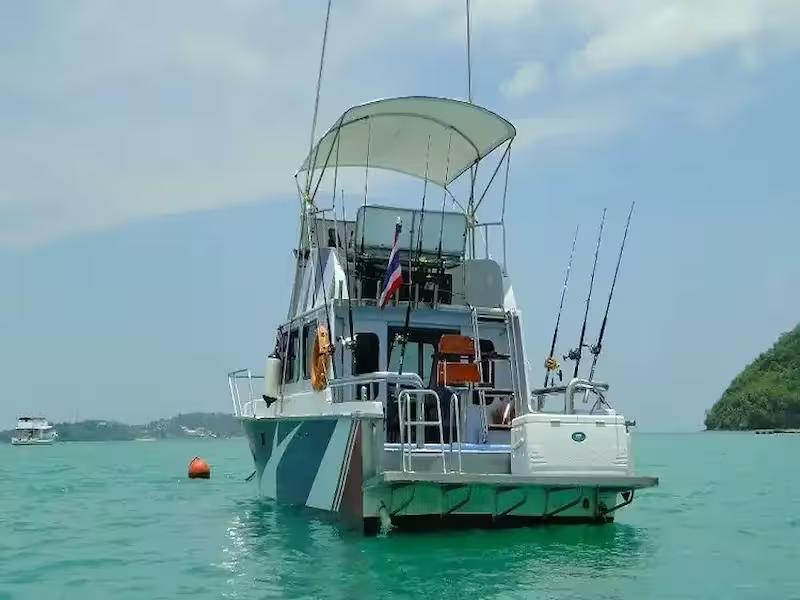 Angler holding a massive marlin catch during big game fishing trip from Phuket