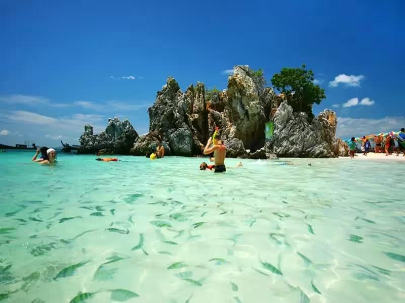 Guests relaxing on the white sandy beach of Khai Island after a scenic speedboat tour to James Bond Island and Phang Nga Bay.