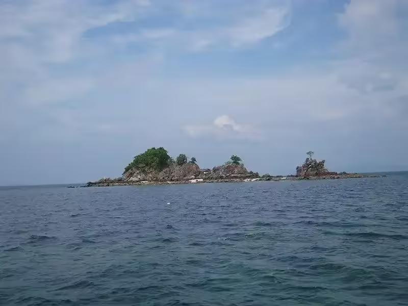 Swimming near the rocky outcrop of Khai Nui Island, the smallest of the Khai Islands