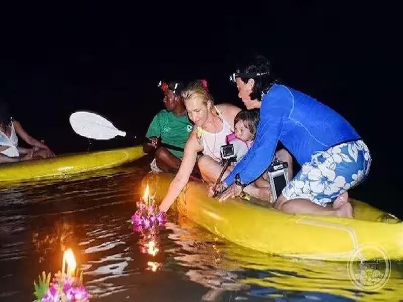 Guests crafting a traditional Thai Krathong (flower basket) on the boat before the starlight ceremony