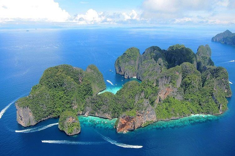 Iconic limestone cliffs of Phi Phi Leh island with turquoise Andaman Sea waters